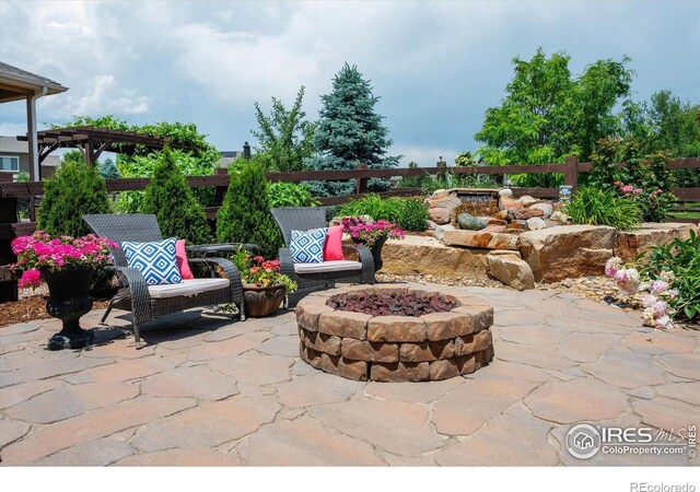 4041 Carroway Seed Dr, Johnstown, CO 80534 - view of patio featuring an outdoor fire pit