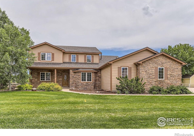 6544 Saddleback Ave, Longmont, CO 80504 - view of front of home featuring stone siding, a front lawn, and roof with shingles