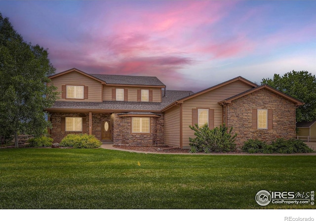 6544 Saddleback Ave, Longmont, CO 80504 - traditional home with stone siding, a front lawn, and roof with shingles