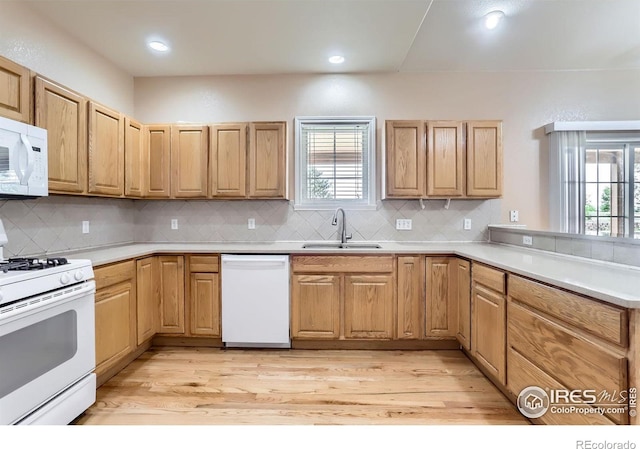 6544 Saddleback Ave, Longmont, CO 80504 - kitchen featuring white appliances, plenty of natural light, decorative backsplash, and recessed lighting
