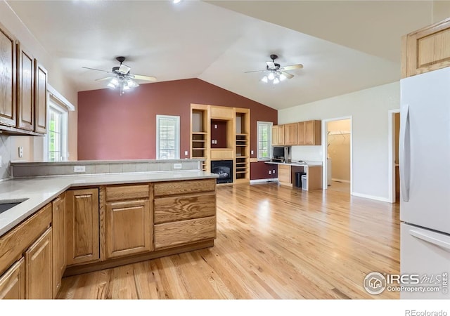 6544 Saddleback Ave, Longmont, CO 80504 - kitchen with freestanding refrigerator, a ceiling fan, light wood-type flooring, lofted ceiling, and healthy amount of natural light