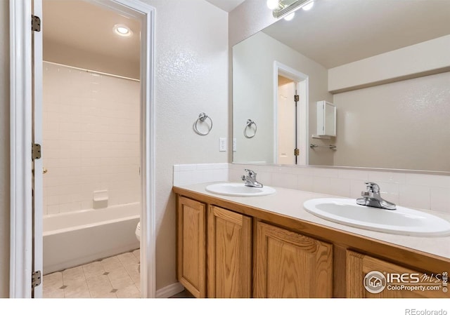 6544 Saddleback Ave, Longmont, CO 80504 - full bathroom with double vanity, washtub / shower combination, and backsplash