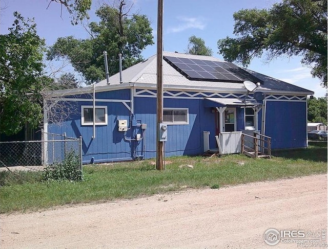 23243 Pawnee Ave, Padroni, CO 80745 - view of front facade with roof mounted solar panels and roof with shingles