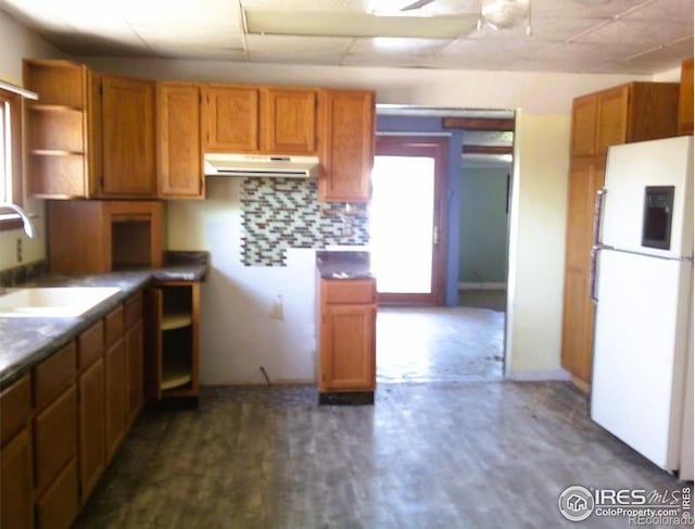 23243 Pawnee Ave, Padroni, CO 80745 - kitchen featuring freestanding refrigerator, range hood, a ceiling fan, and brown cabinets