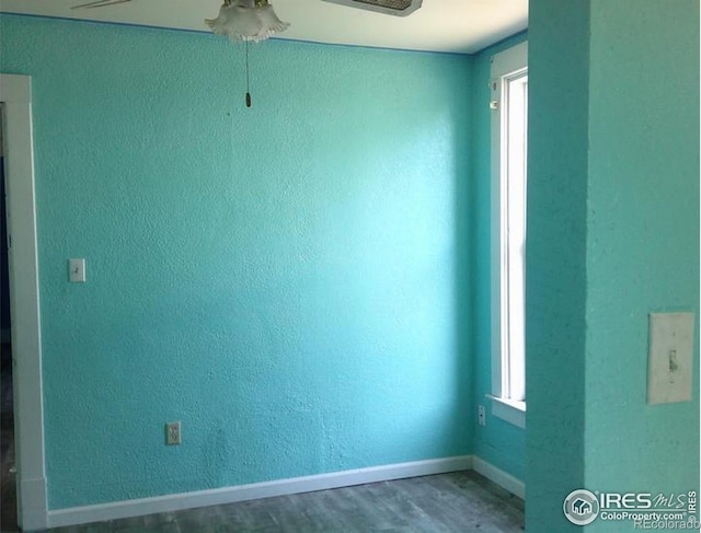 23243 Pawnee Ave, Padroni, CO 80745 - spare room with ceiling fan, wood finished floors, and a textured wall