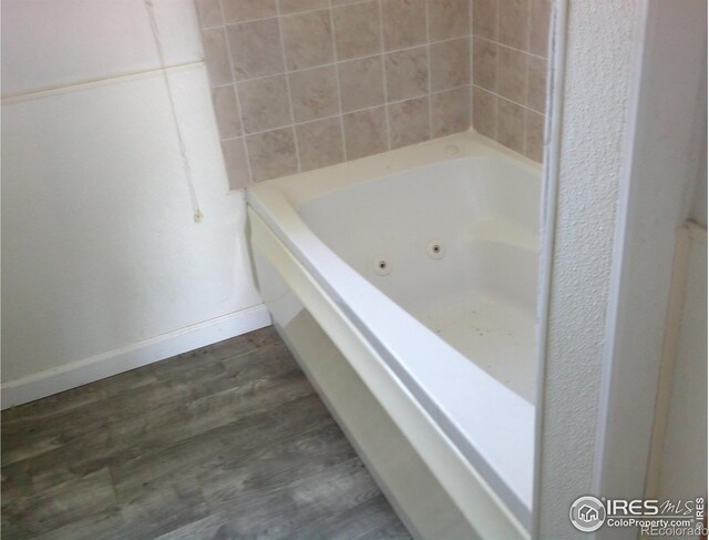 23243 Pawnee Ave, Padroni, CO 80745 - full bathroom with a jetted tub and wood finished floors