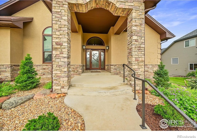 8406 Spinnaker Bay Dr, Windsor, CO 80528 - doorway to property featuring stone siding and stucco siding