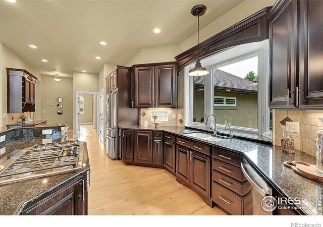 8406 Spinnaker Bay Dr, Windsor, CO 80528 - kitchen featuring stainless steel appliances, light wood-type flooring, dark stone counters, dark brown cabinetry, and recessed lighting