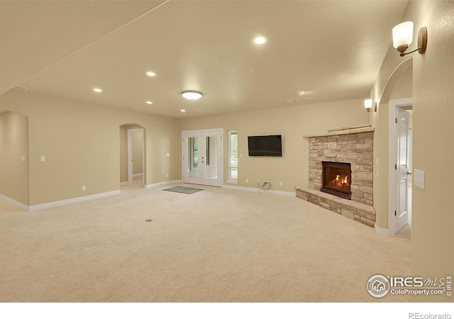 8406 Spinnaker Bay Dr, Windsor, CO 80528 - unfurnished living room with carpet, a fireplace, recessed lighting, and arched walkways