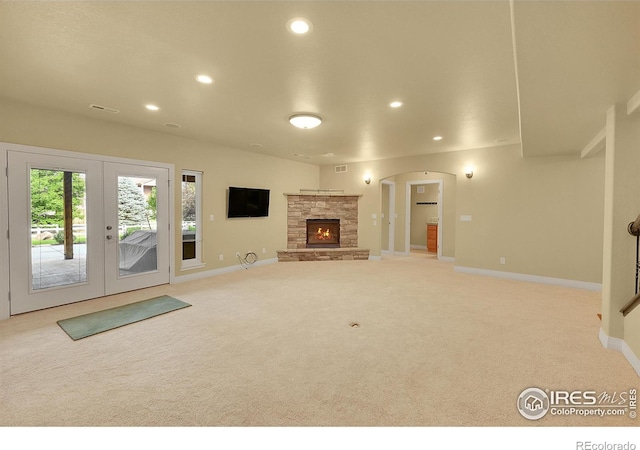 8406 Spinnaker Bay Dr, Windsor, CO 80528 - unfurnished living room with carpet flooring, recessed lighting, french doors, and a stone fireplace