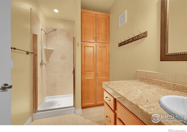 8406 Spinnaker Bay Dr, Windsor, CO 80528 - bathroom with a shower stall, vanity, and tile patterned floors