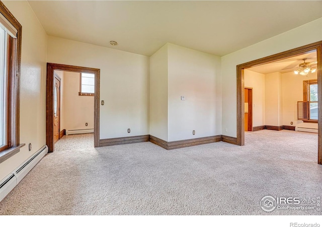 1906 Miner St, Idaho Springs, CO 80452 - carpeted empty room with a baseboard heating unit, plenty of natural light, and a ceiling fan