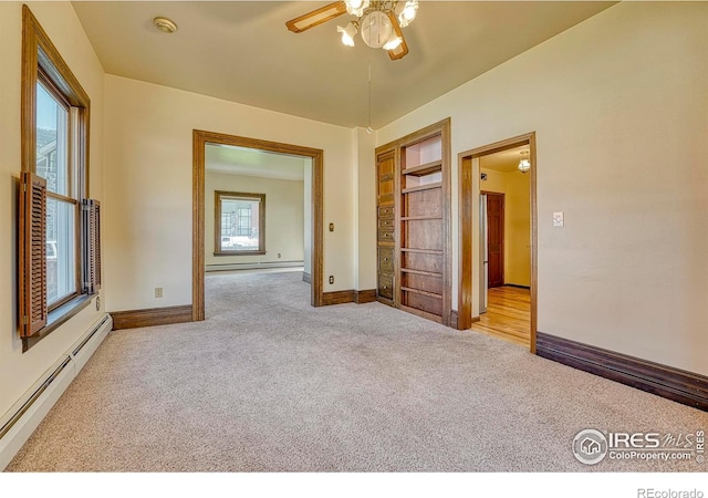 1906 Miner St, Idaho Springs, CO 80452 - carpeted spare room with baseboard heating, ceiling fan, a baseboard heating unit, a smoke detector, and built in shelves