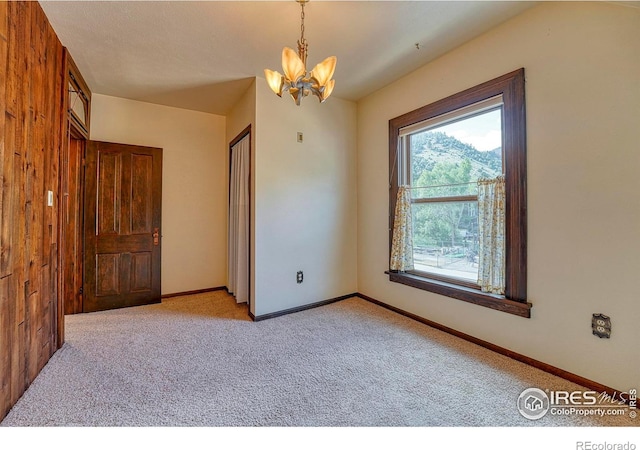 1906 Miner St, Idaho Springs, CO 80452 - unfurnished bedroom featuring a chandelier and light colored carpet