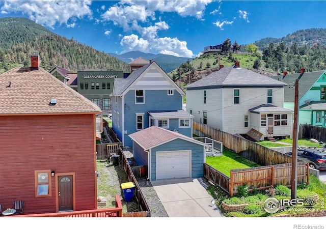 1906 Miner St, Idaho Springs, CO 80452 - view of front of home featuring a mountain view, a detached garage, and concrete driveway