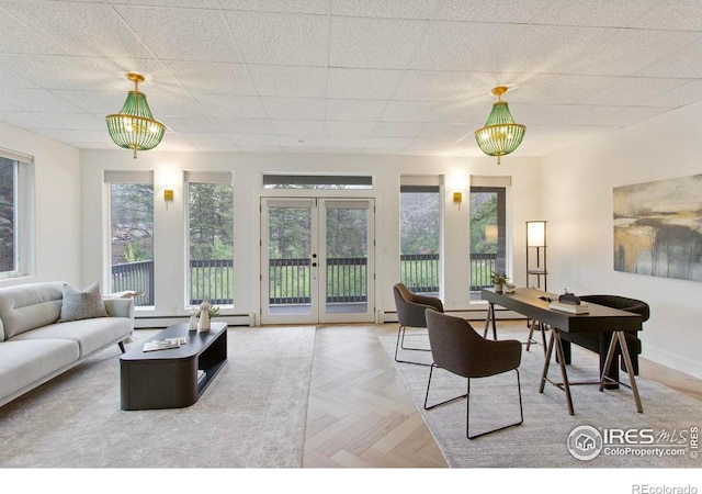 11042 N Saint Vrain Dr, Lyons, CO 80540 - living area with plenty of natural light, a drop ceiling, french doors, and baseboard heating