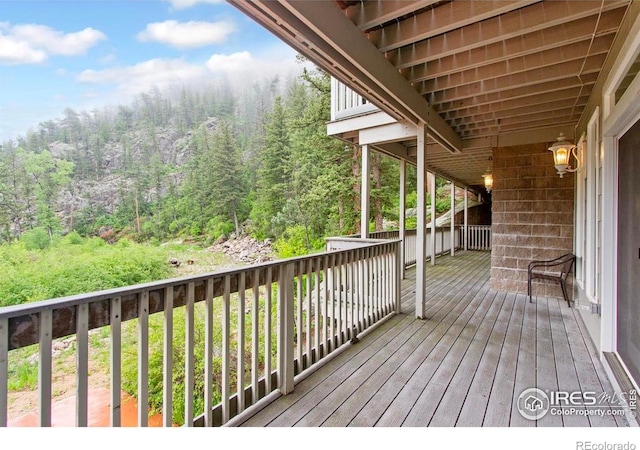 11042 N Saint Vrain Dr, Lyons, CO 80540 - wooden deck with a wooded view