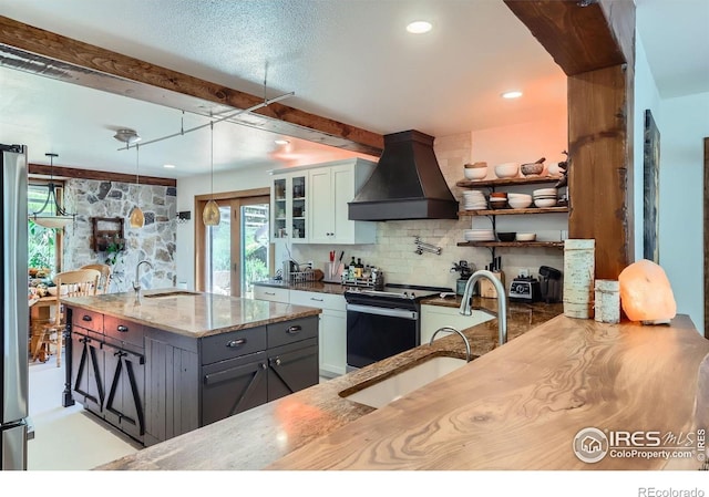 148 Granite Dr, Boulder, CO 80302 - kitchen with premium range hood, stainless steel electric range, tasteful backsplash, light stone counters, and glass insert cabinets