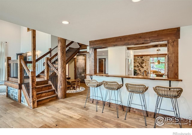 148 Granite Dr, Boulder, CO 80302 - kitchen with wood finished floors, stainless steel refrigerator with ice dispenser, a breakfast bar, and recessed lighting