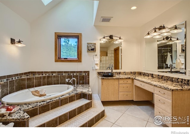 148 Granite Dr, Boulder, CO 80302 - bathroom featuring a bath, vanity, tile patterned floors, lofted ceiling, and a skylight