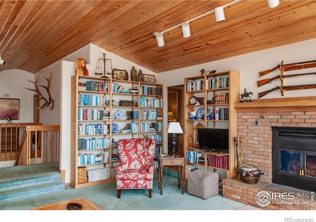 118 Alpine Dr, Estes Park, CO 80517 - living area with carpet floors, vaulted ceiling, a brick fireplace, and wood ceiling
