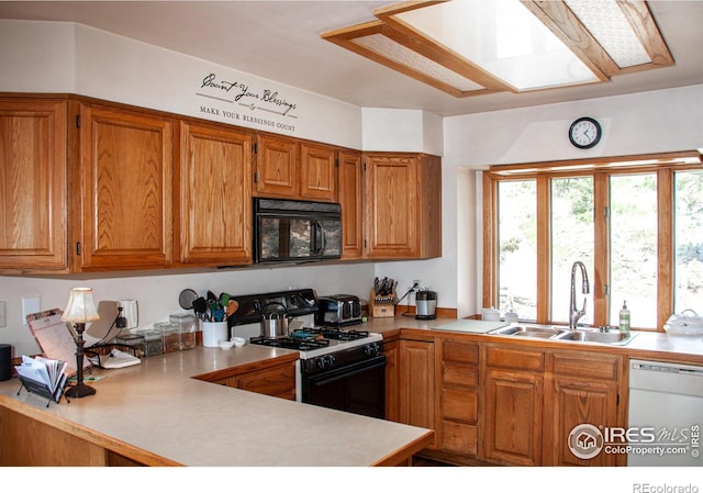 118 Alpine Dr, Estes Park, CO 80517 - kitchen featuring black microwave, gas range, dishwasher, light countertops, and brown cabinets