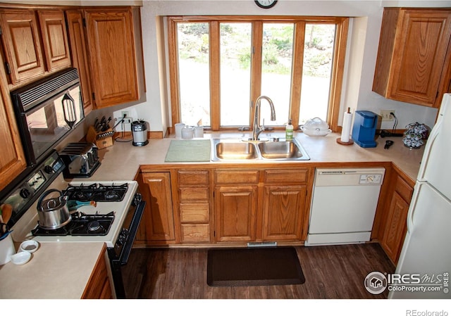 118 Alpine Dr, Estes Park, CO 80517 - kitchen featuring white appliances, light countertops, brown cabinetry, and dark wood-style floors