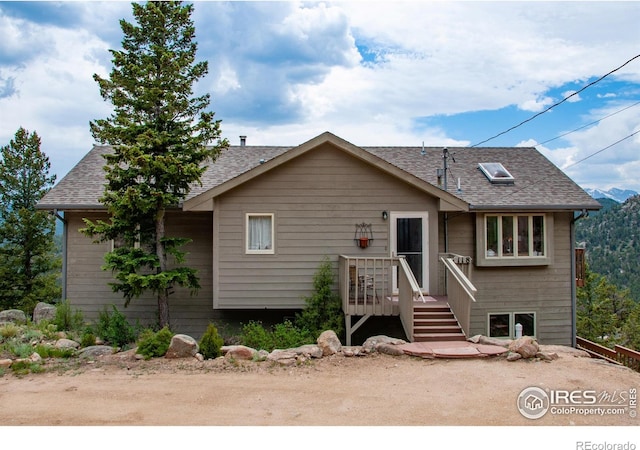 118 Alpine Dr, Estes Park, CO 80517 - view of front of home with a deck and a shingled roof