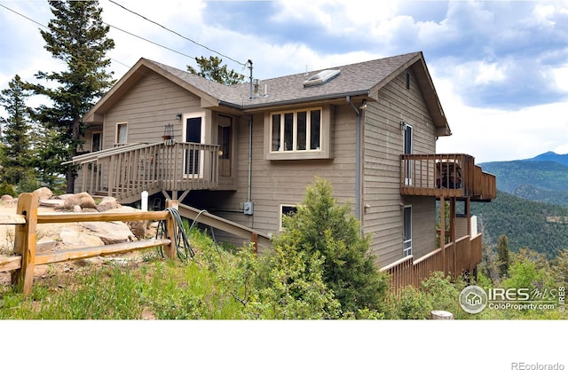 118 Alpine Dr, Estes Park, CO 80517 - rear view of house with a mountain view, a balcony, and roof with shingles