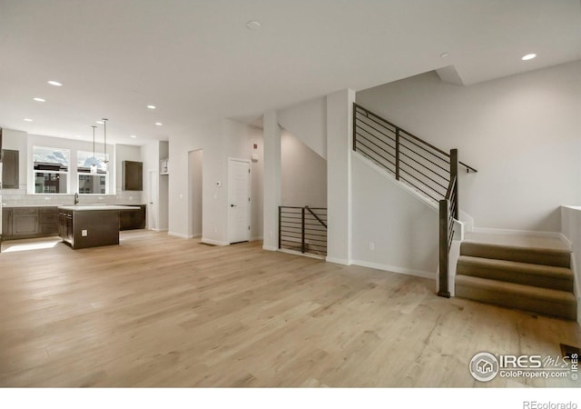 362 Promenade Dr, Superior, CO 80027 - unfurnished living room with light wood-style floors, recessed lighting, and stairs