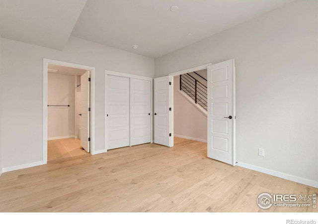 362 Promenade Dr, Superior, CO 80027 - unfurnished bedroom with light wood-type flooring, connected bathroom, and a closet