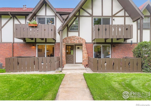 3250 Oneal Cir Unit 10, Boulder, CO 80301 - tudor-style house with stucco siding, a balcony, brick siding, and a front yard