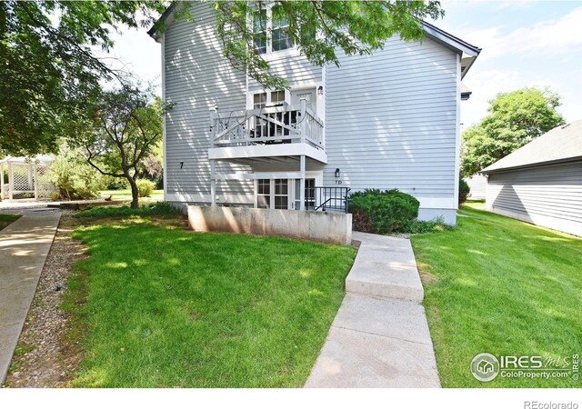 1601 W Swallow Rd Unit D, Fort Collins, CO 80526 - back of property featuring a yard and a balcony