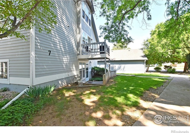 1601 W Swallow Rd Unit D, Fort Collins, CO 80526 - view of property exterior with a yard and a wooden deck