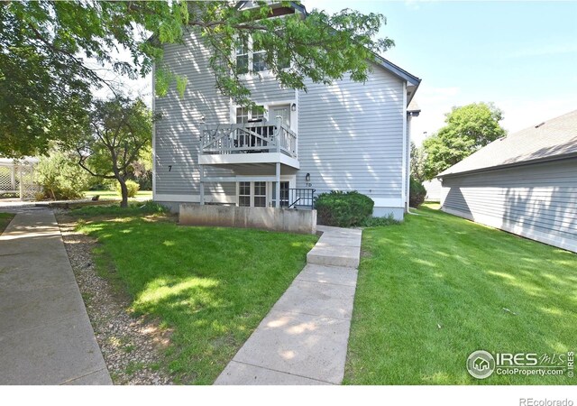 1601 W Swallow Rd Unit D, Fort Collins, CO 80526 - rear view of house with a yard