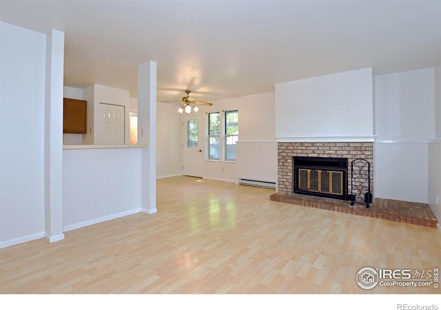 1601 W Swallow Rd Unit D, Fort Collins, CO 80526 - unfurnished living room with a baseboard radiator, wood finished floors, ceiling fan, and a brick fireplace