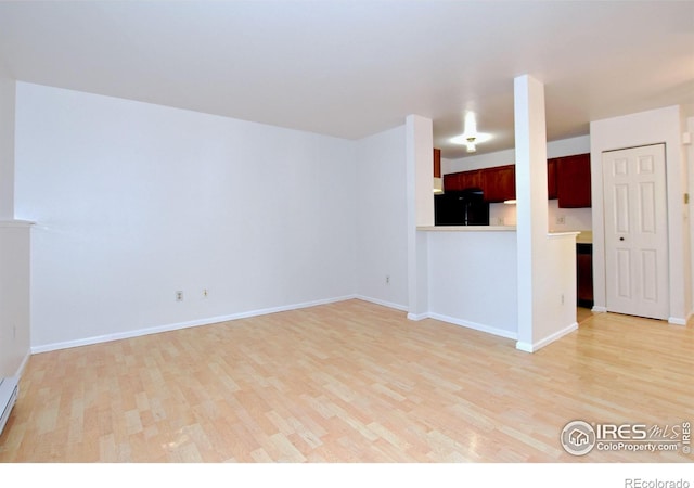 1601 W Swallow Rd Unit D, Fort Collins, CO 80526 - unfurnished living room with light wood-type flooring and a baseboard radiator
