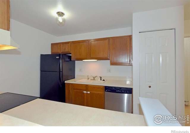 1601 W Swallow Rd Unit D, Fort Collins, CO 80526 - kitchen with stainless steel dishwasher, freestanding refrigerator, brown cabinets, light countertops, and cooktop