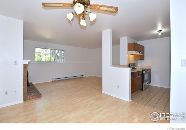 1601 W Swallow Rd Unit D, Fort Collins, CO 80526 - kitchen with stainless steel electric range oven, under cabinet range hood, a baseboard heating unit, a ceiling fan, and light wood-type flooring
