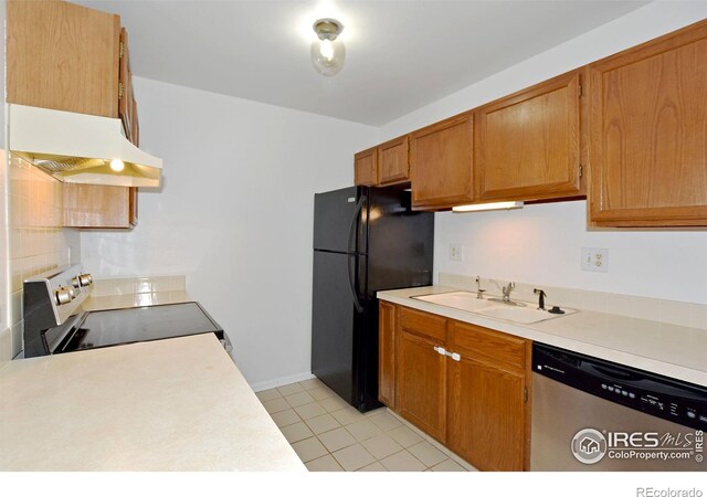 1601 W Swallow Rd Unit D, Fort Collins, CO 80526 - kitchen featuring stainless steel dishwasher, range with electric cooktop, under cabinet range hood, freestanding refrigerator, and light countertops