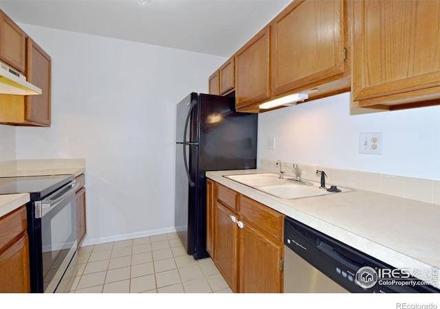 1601 W Swallow Rd Unit D, Fort Collins, CO 80526 - kitchen with stainless steel appliances, light countertops, under cabinet range hood, and brown cabinetry
