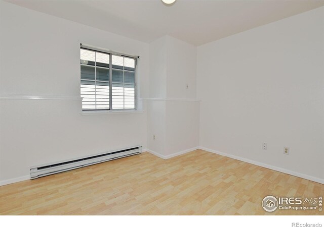 1601 W Swallow Rd Unit D, Fort Collins, CO 80526 - unfurnished room with a baseboard radiator and wood finished floors