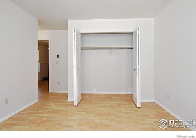 1601 W Swallow Rd Unit D, Fort Collins, CO 80526 - unfurnished bedroom with wood finished floors and a closet