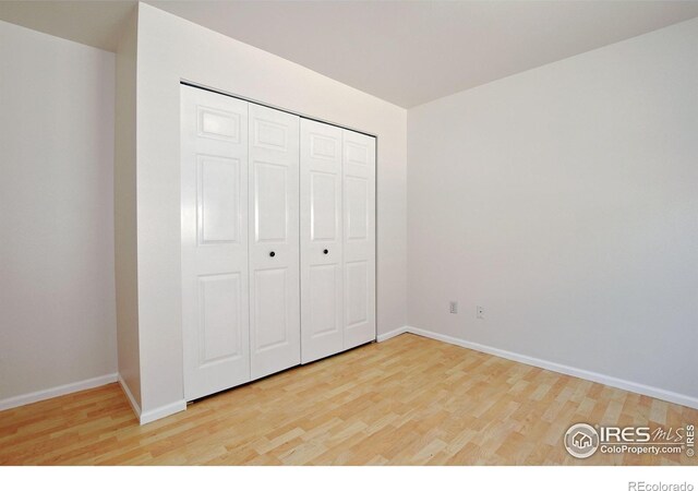 1601 W Swallow Rd Unit D, Fort Collins, CO 80526 - unfurnished bedroom with wood finished floors and a closet