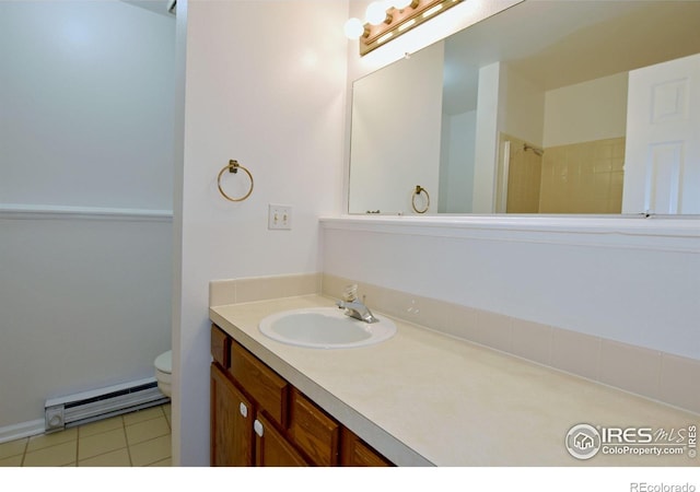 1601 W Swallow Rd Unit D, Fort Collins, CO 80526 - full bathroom featuring a baseboard radiator, vanity, and tile patterned flooring
