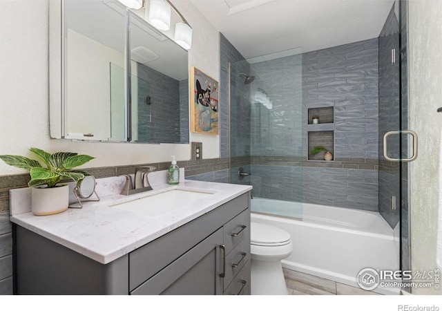 4863 W Moorhead Cir, Boulder, CO 80305 - bathroom with vanity, bath / shower combo with glass door, and tile walls