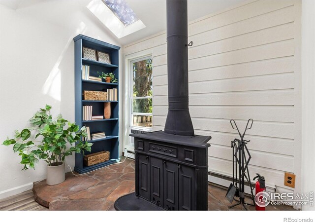 4863 W Moorhead Cir, Boulder, CO 80305 - detailed view of a wood stove, a skylight, and baseboard heating