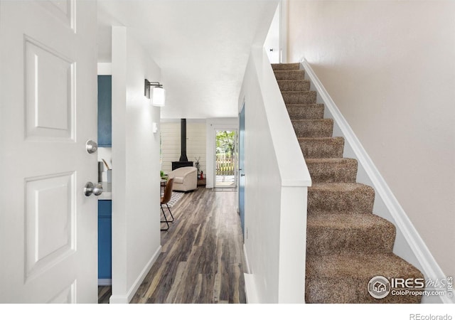 4863 W Moorhead Cir, Boulder, CO 80305 - staircase with wood finished floors and a wood stove