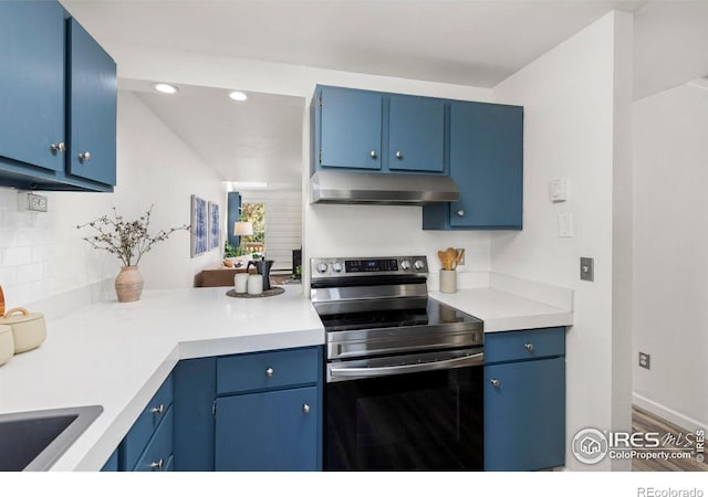 4863 W Moorhead Cir, Boulder, CO 80305 - kitchen with under cabinet range hood, stainless steel electric stove, blue cabinetry, light countertops, and recessed lighting