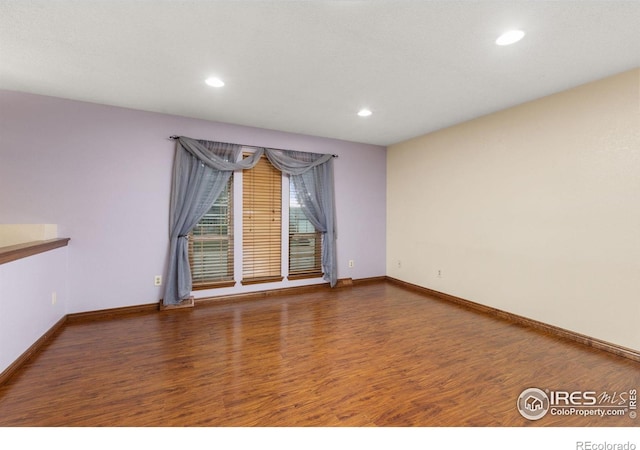 3207 Valmont St, Evans, CO 80620 - spare room featuring wood finished floors and recessed lighting